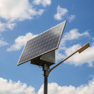 Solar-powered street lamp against the blue sky
